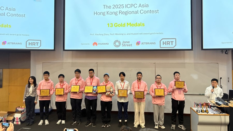 
Nine gold medalists posing together with their medals.
